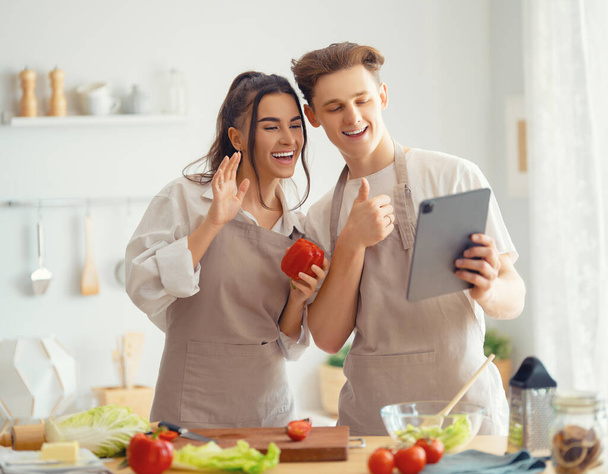 Healthy food at home. Happy loving couple is preparing the proper meal in the kitchen. - Fotoğraf, Görsel