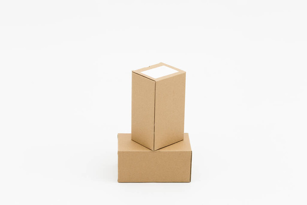 Two closed cardboard boxes on a white background - Foto, afbeelding