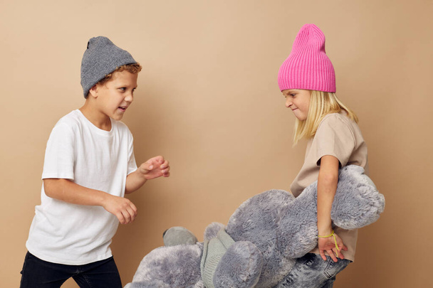Cute stylish children in hats with a teddy bear friendship Lifestyle unaltered - Fotó, kép