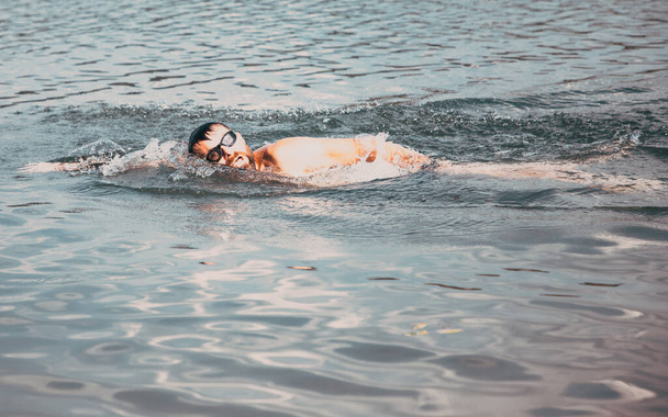 man swimming in open water lake - Photo, Image