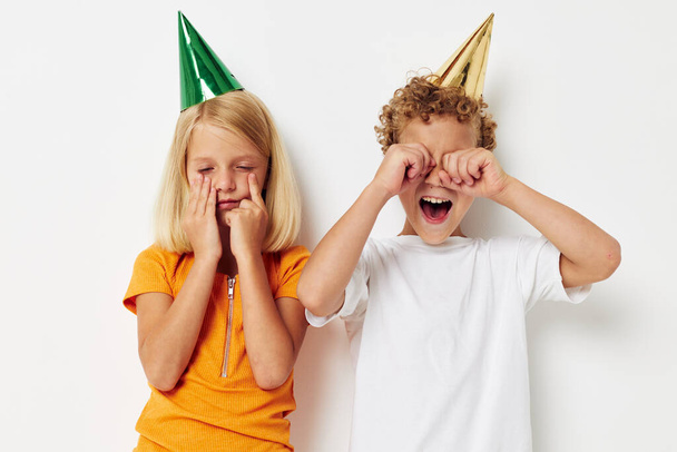 Cute preschool kids in multicolored caps birthday holiday emotion lifestyle unaltered - Foto, imagen
