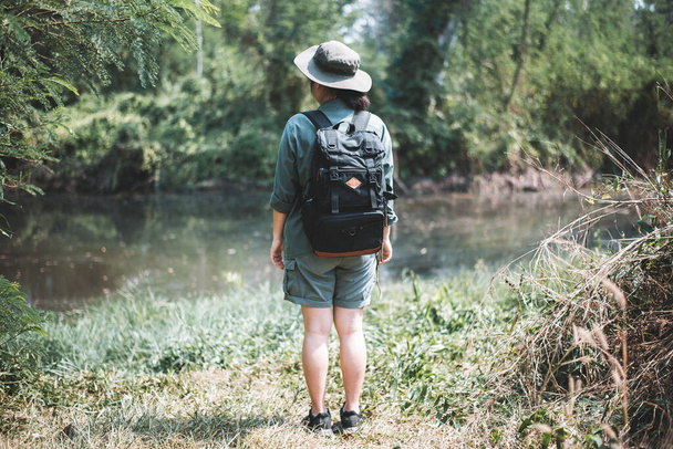 Молода жінка з рюкзаком дикі пригоди на тропічних канікулах концепція ліс і озеро
 - Фото, зображення