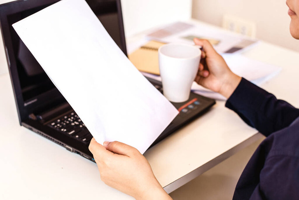 Business woman holding a cup of coffee and files - Photo, Image