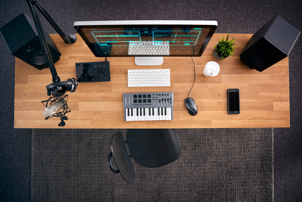 Overhead View Of Music Workstation With Keyboard And Microphone In Studio - Фото, зображення