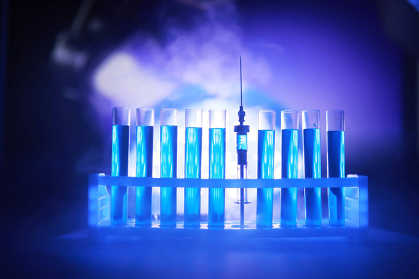 Test tube of glass overflows new liquid solution potassium blue conducts an analysis reaction takes various versions reagents using chemical pharmaceutics cancer manufacturing  - Photo, Image