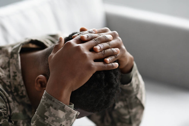 Unrecognizable military black man covering his head with palms - Foto, Imagem