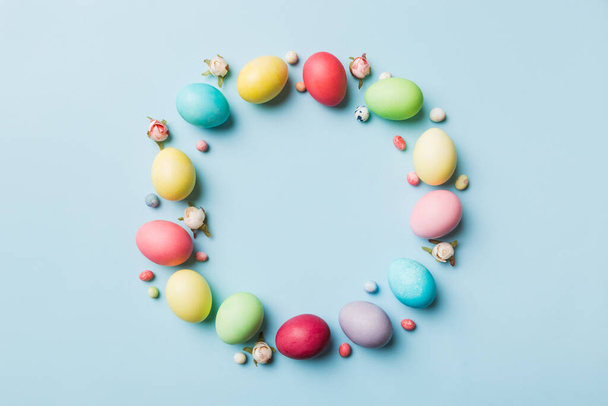 round frame Multi colors Easter eggs on colored background . Pastel color Easter eggs holiday concept with empty space for you design. - Photo, image