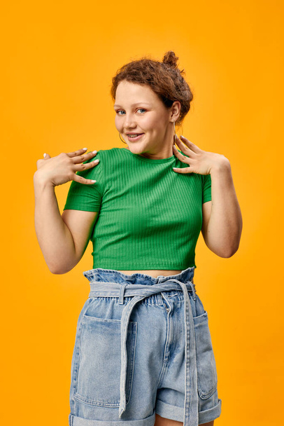 cheerful pretty girl in summer clothes posing yellow background - Fotografie, Obrázek