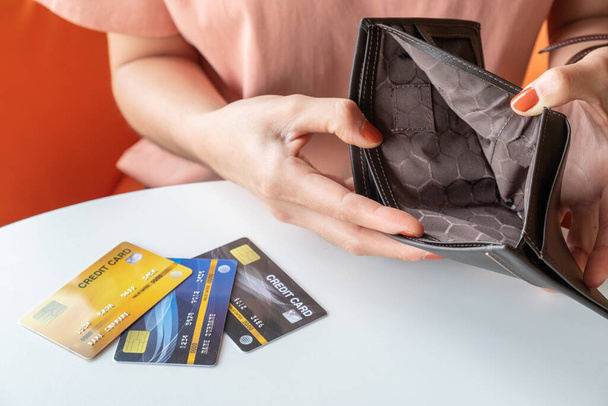 Close-up of woman hands open an empty wallet, Bad economics situation but she still have some credit cards. Conceptual of unhappy bankrupt woman. - Photo, Image