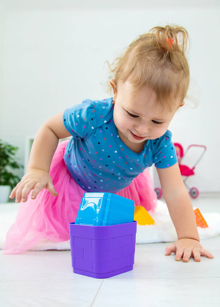 Ein Baby spielt im Spielzimmer mit Spielzeug. Selektiver Fokus. Kind. - Foto, Bild