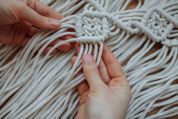 Close-up of the hand of a girl who weaves macrame technique - Foto, imagen
