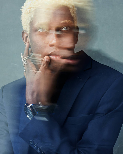 Portrait of a dark-skinned guy with white hair and jewelry on his hand - Zdjęcie, obraz