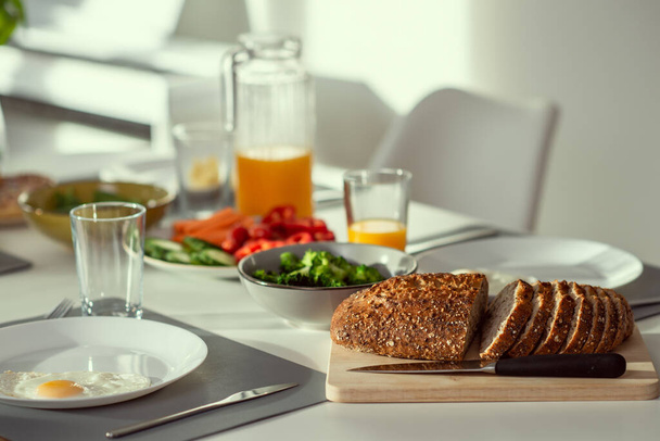 Breakfast closeup with eggs, wholegrain bread, green fresh broccoli, and orange juice - Фото, изображение