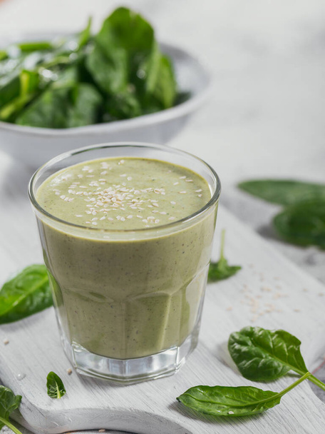 Glass of homemade healthy green smoothie with fresh baby spinach - Photo, Image