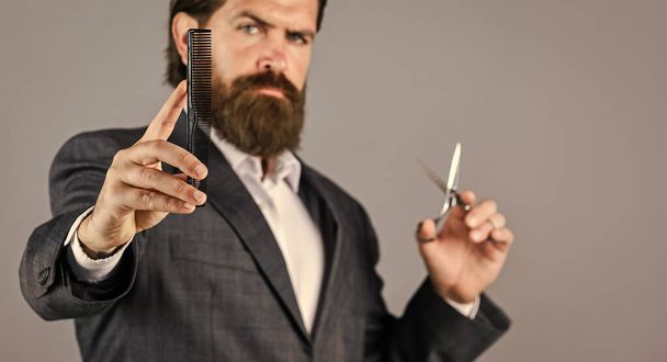 his perfect style. Mature hipster with beard. brutal caucasian hipster with moustache. Male barber care. Bearded man hold hair brush and scissors. Confident and handsome brutal man. facial care - Foto, immagini