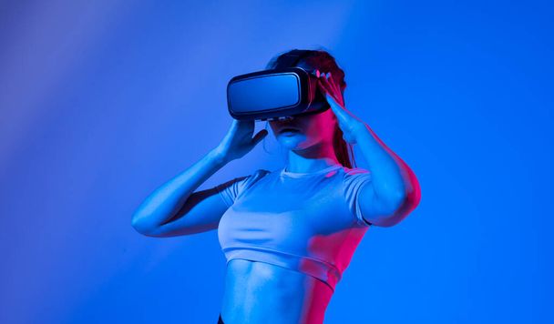 Female architector wearing virtual reality headset and making gestures with hands. VR technology for industrial design, development, architecting. - Foto, afbeelding