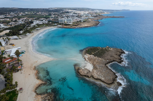 Aerial drone view of the coastline of empty beach in winter. Summer holidays. Nissi beach Ayia Napa, Cyprus - Photo, Image