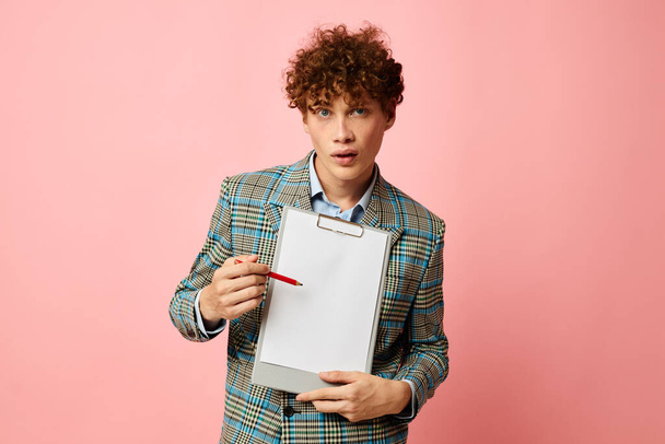 guy with red curly hair in a plaid jacket copy-space folder isolated background unaltered - Foto, Bild