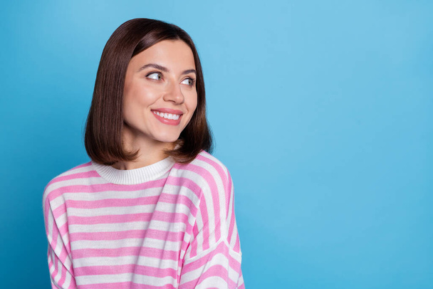 Photo of impressed millennial brunette lady look empty space wear pink jumper isolated on blue background - Φωτογραφία, εικόνα