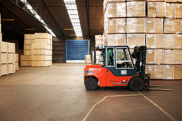 Our service is shipping good. A large warehouse storing big wooden boxes with a forklift. - Photo, Image