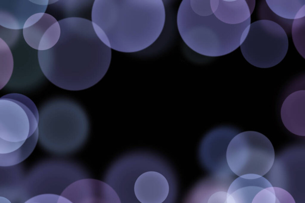 Beautiful black background with many blurry purple lights similar to bokeh - Фото, изображение