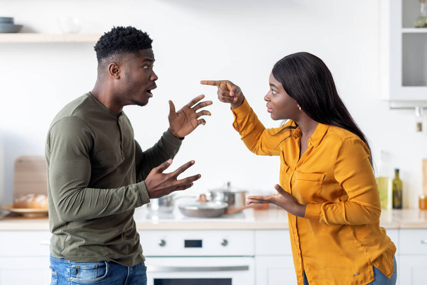 Lovers Fight. Portrait Of Andry Black Couple Emotionally Arguing In Kitchen - Photo, Image
