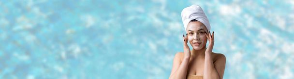 Beauty portrait of woman in white towel on head applies cream to the face. Skincare cleansing eco organic cosmetic spa relax concept. - Photo, Image