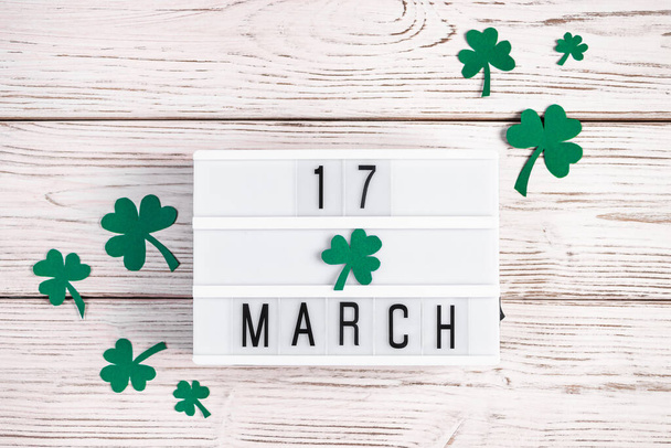 Concept for St. Patrick's Day - March 17th. Shamrock clover leaves on white wooden background. Festive flatlay - Foto, Bild