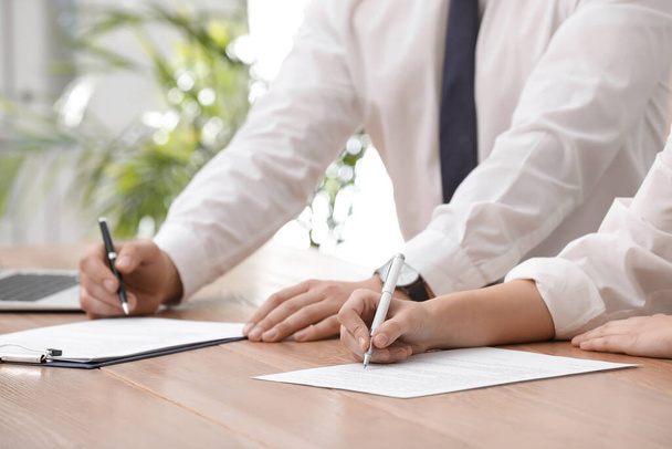 Woman signing contract at table in office, closeup. - Foto, Imagem