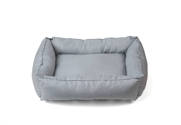 Soft grey pet bed isolated on a white background. Accessories for pets. - Photo, Image