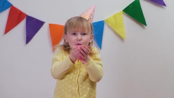 Happy Girl In Party Hat Celebrating At Birthday Party Blowing Handful Of colorful Confetti - Footage, Video
