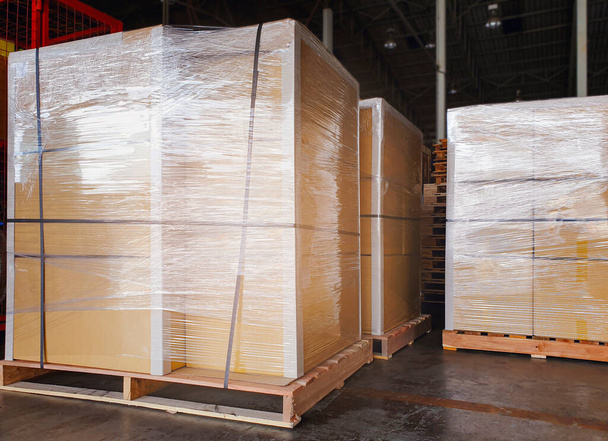 Packaging Boxes Wrapped Plastic Film on Pallets in Storage Warehouse. Supply Chain. Storehouse Commerce Shipment. Shipping Warehouse Logistics. - Photo, Image