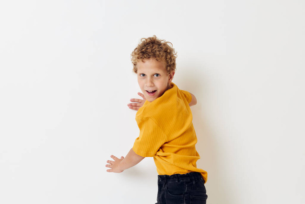 boy with curly hair in yellow t-shirt cropped view - Фото, зображення