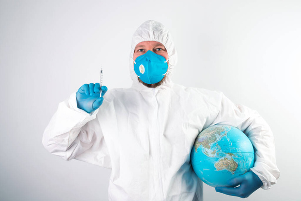 Pandemic concept, close up of scientist injecitng vaccine into the earth. Concept fight against virus. - Foto, Bild