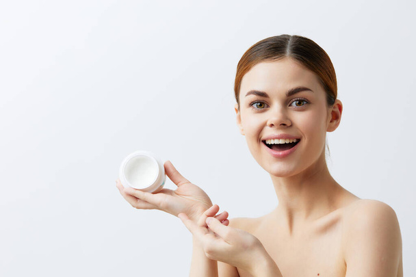 crema corporal mujer posando cuidado de la piel limpia aspecto atractivo fondo claro - Foto, Imagen
