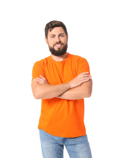 Handsome man in bright orange t-shirt on white background - Foto, Imagen