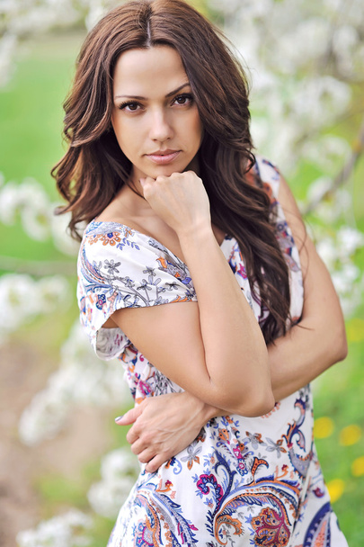 Portrait of a beautiful young brunette woman outdoor - Photo, Image