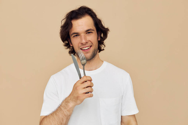 Attractive man cutlery in hand posing Lifestyle unaltered - Foto, immagini