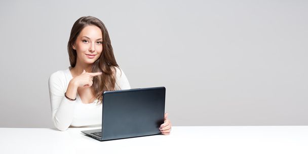 Gorgeous brunette using laptop. - Foto, imagen