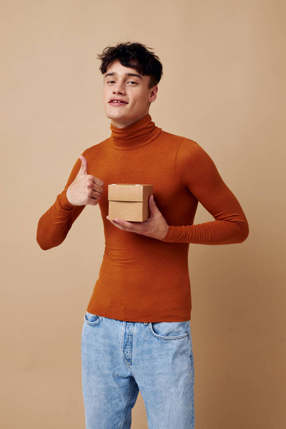 A young man brown turtleneck posing fashion light background unaltered - Photo, Image