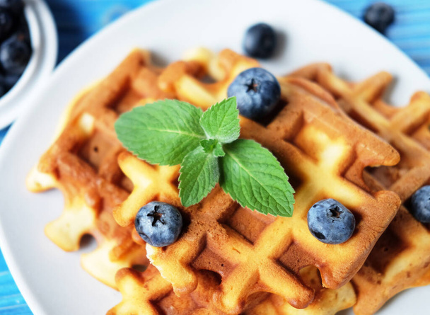 Homemade Belgian waffles served with fresh berries on white plate over wooden background, close up. Top view. Flat lay,Tasty. Sweet. - Foto, immagini