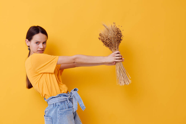 attractive woman in a yellow t-shirt flax bouquet emotions summer style isolated background - Φωτογραφία, εικόνα