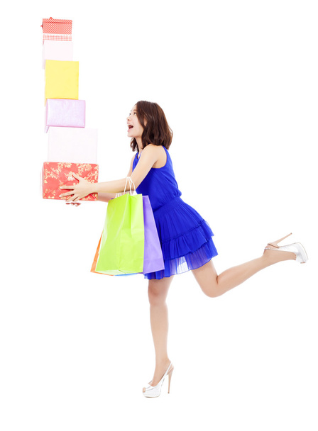 beautiful young woman holding shopping bag and gift boxes - Photo, Image