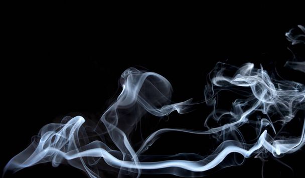 Διεστραμμένα στίγματα καπνού, κίνηση καπνού σε μαύρο φόντο. Αφηρημένες γραμμές καπνού  - Φωτογραφία, εικόνα