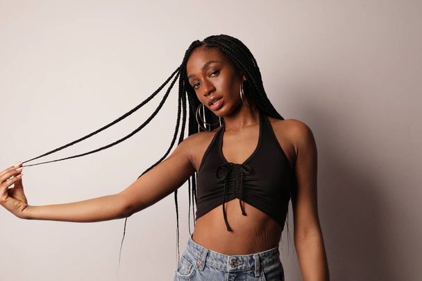 Confident serious young afro American woman with shining skin and long braids. - Foto, Imagem
