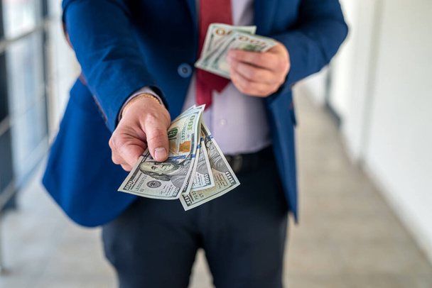 бизнесмен дает нам деньги в офисе. финансовая концепция. оплата - Фото, изображение