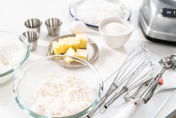 Ingredient to bake coconut cookies on the kitchen counter. - Fotó, kép