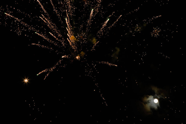 Fireworks in the night sky with moon. - Photo, Image