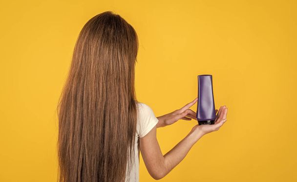 teen girl wash long straight hair with shampoo and condirioner, hairdresser - 写真・画像