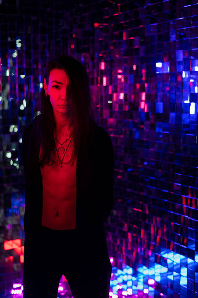 Portrait of a male transgender model in neon light. - Foto, imagen